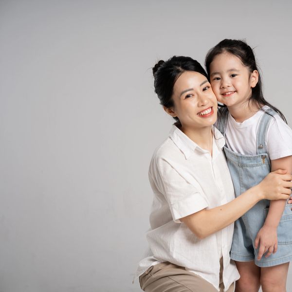 Mother and daughter sharing a warm hug and smile.