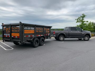 Dumpster Trailer pulled by a pickup truck