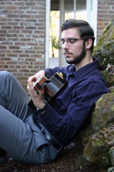 Isaac Engel playing a guitar in nature