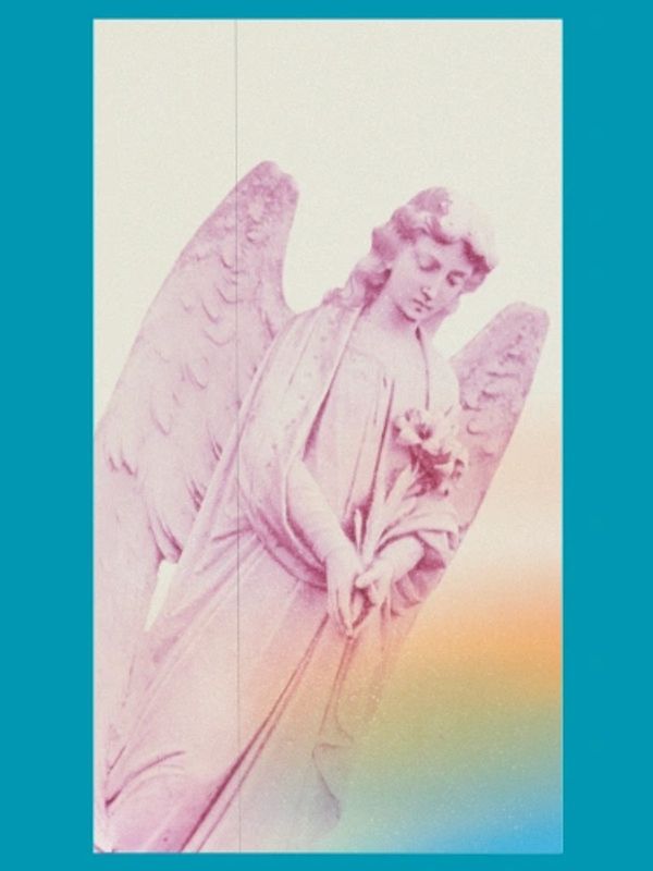 Pink angel statue with wings holding flowers against a soft gradient background.