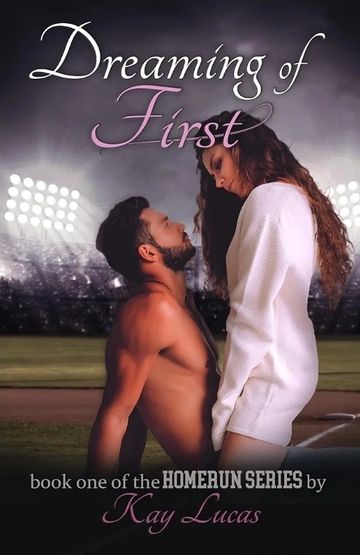 Couple in an intimate moment on a baseball field at night.