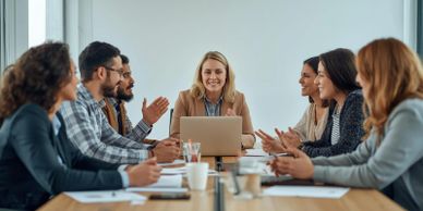 A group of six people in a business meeting around a table.