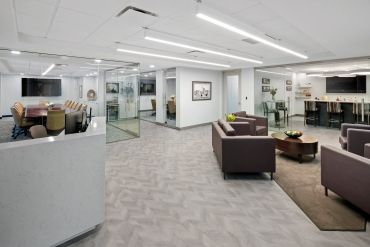 Modern office space with seating areas and conference room.