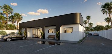 Modern black and white commercial building with parking.