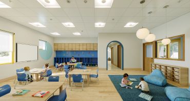 Children reading and playing in a modern classroom.