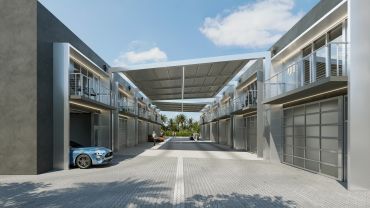 Modern townhouse complex with sleek design and parked car.
