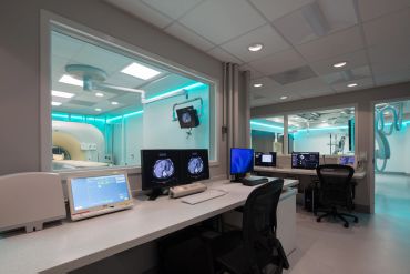 Modern medical imaging control room with advanced monitors.