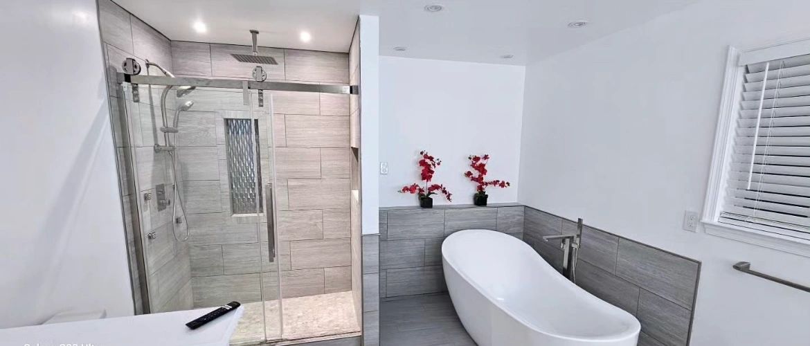 Modern bathroom with a glass shower and a freestanding bathtub.