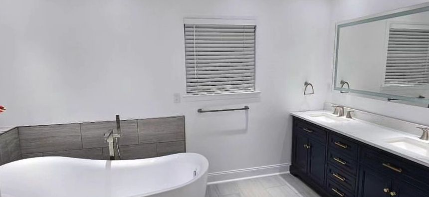 Modern bathroom with a freestanding tub and double vanity.