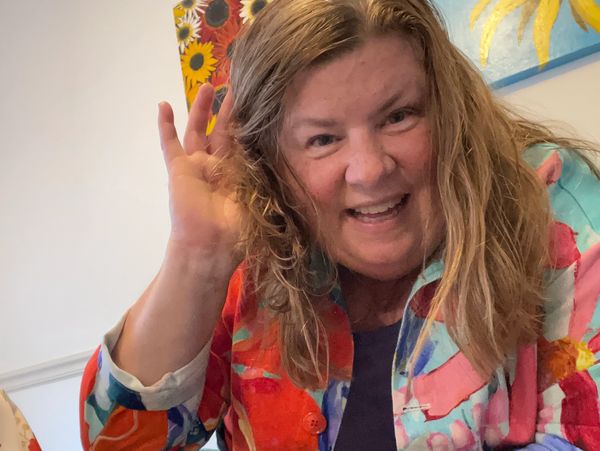 Kirsten Klug indicating she is listening to you are ready to learn and converse with you.