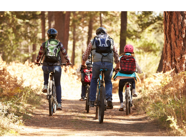 Family cycling through the woods