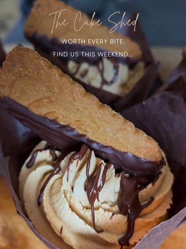 Decadent cupcakes topped with creamy frosting, chocolate drizzle, and a biscuit for crunch.
