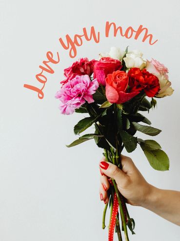 Hand holding colorful flowers with 'Love you mom' text.