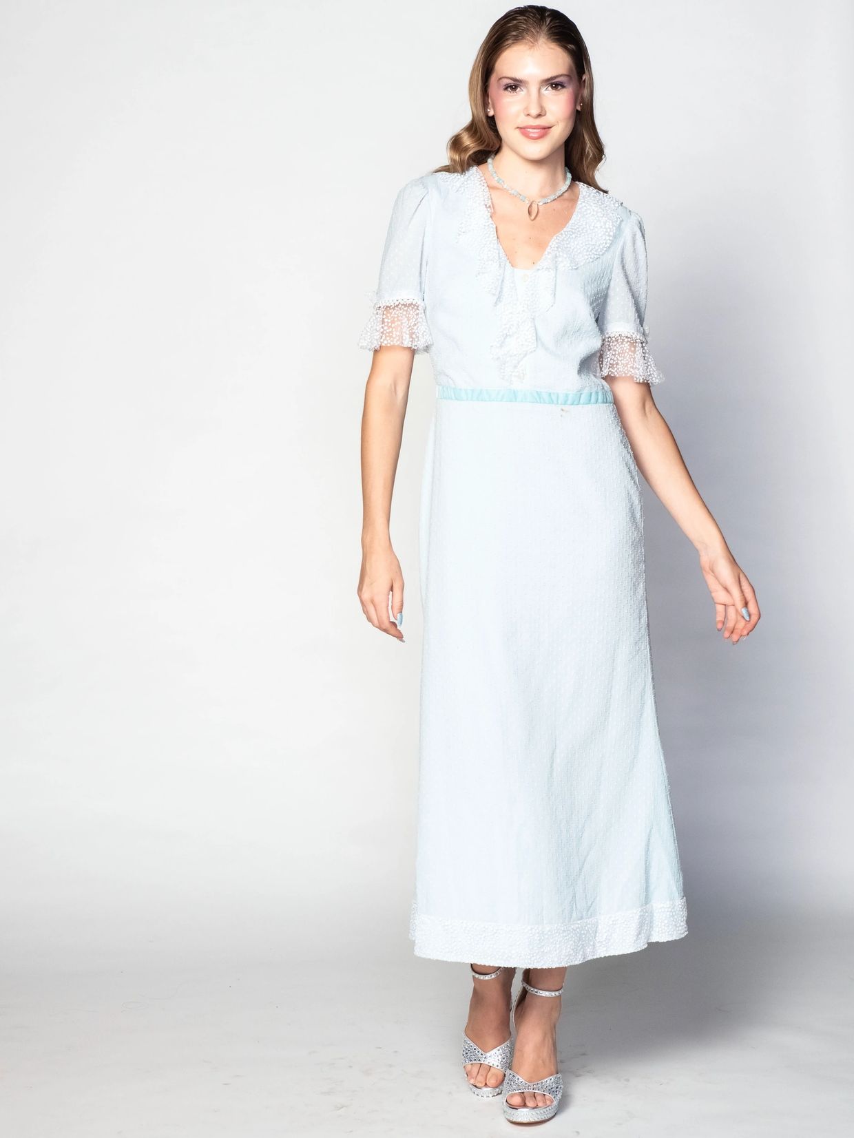 Woman in a light blue vintage-inspired dress.