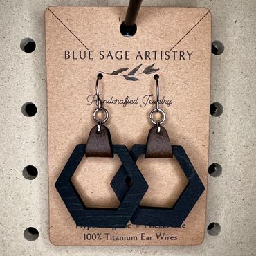 Black hexagon hanging from faux leather hanging earrings
