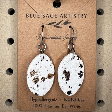 White oval hanging clay earrings
