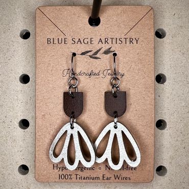 3 teardrop earrings connected to faux leather piece