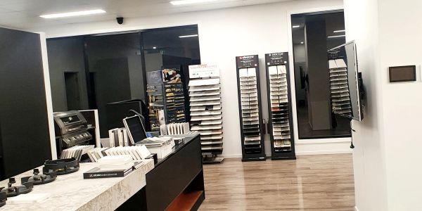 Showroom with sample boards and display racks.