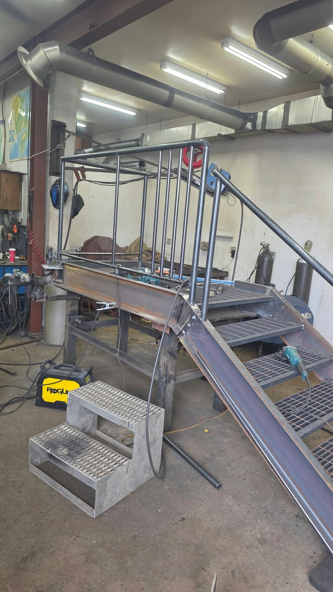 Metal ramp and stairs under construction in workshop.