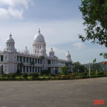 Historic white palace with domes under a blue sky.