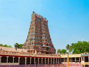 Colorful ancient Hindu temple tower under clear sky.