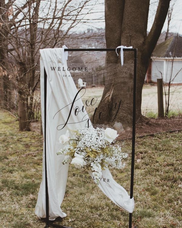 An elegant standing frame with floral wedding sign. 