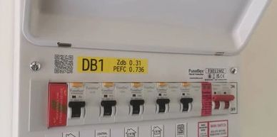 Electrical distribution board with circuit breakers labeled DB1.