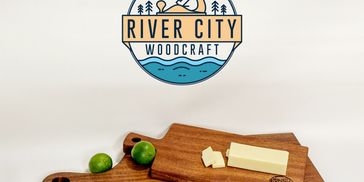 River City Woodcraft Logo with two sapele charcuterie boards. 