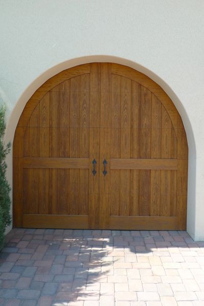 Clear cypress cladded faux wood garage door with decorative handles