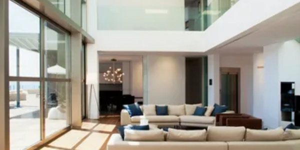 Bright modern living room with large windows and comfortable seating.
