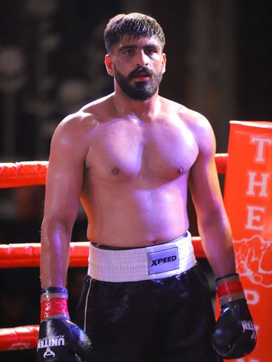Boxer standing in a ring, ready for a match.