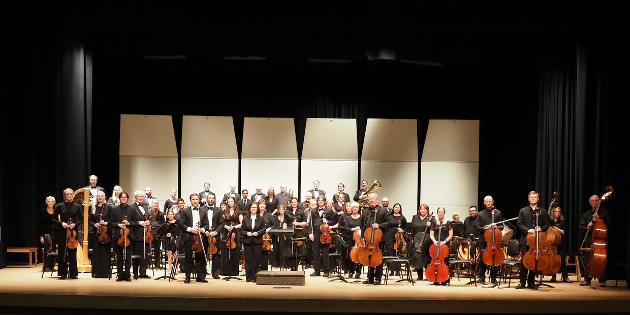 Full orchestra on stage with instruments.