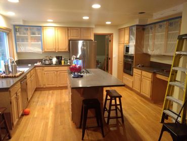 Spacious kitchen with wooden cabinets and island seating.