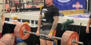 Athlete lifting heavy barbell at MAS Wrestling USA World Championship.