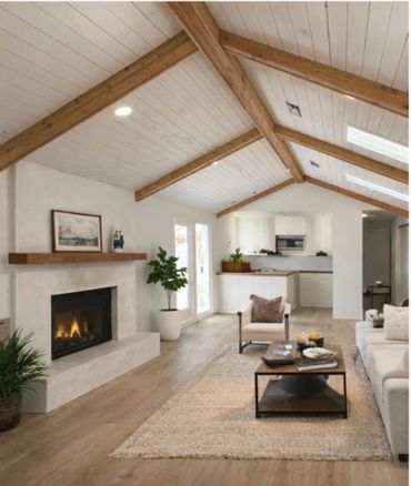 Modern living room with fireplace and wooden beams.