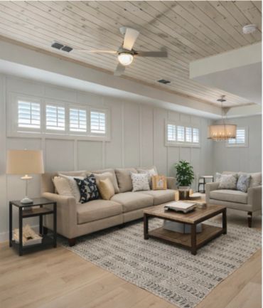 Modern cozy living room with beige sofas and wooden ceiling.