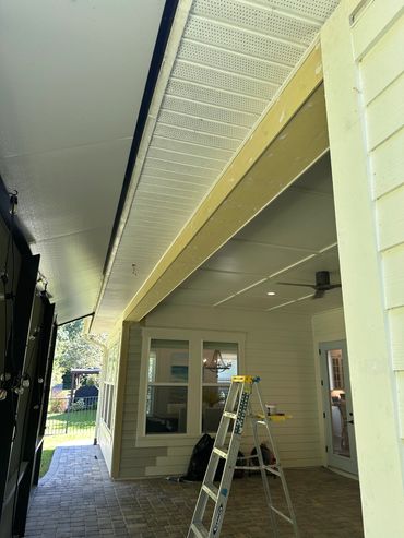 Outdoor covered patio area with ladder.
