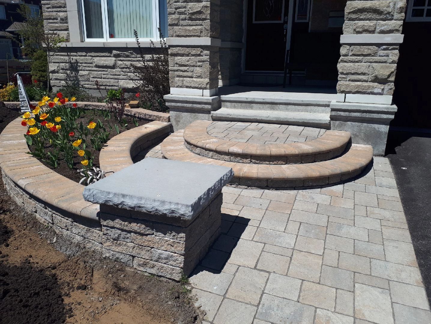 Stone house entrance with paver steps.
