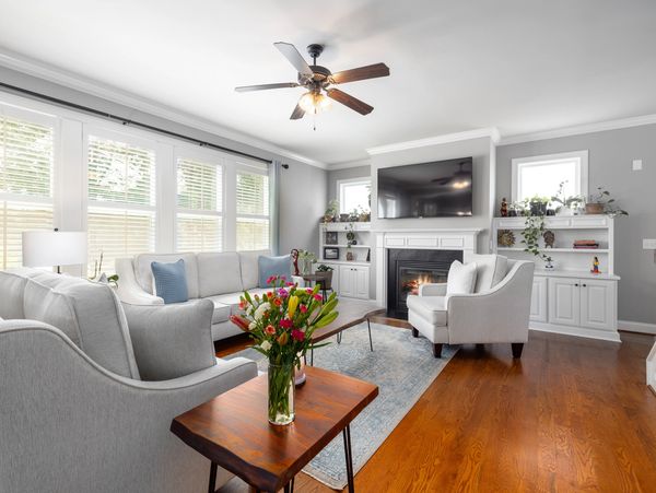 A living room with couch, armchairs and fireplace