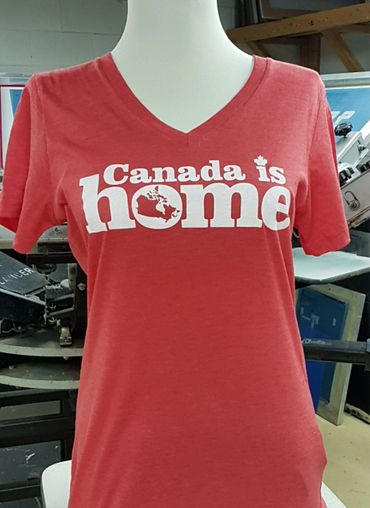 Red T-shirt with "Canada is home" text and a maple leaf design.