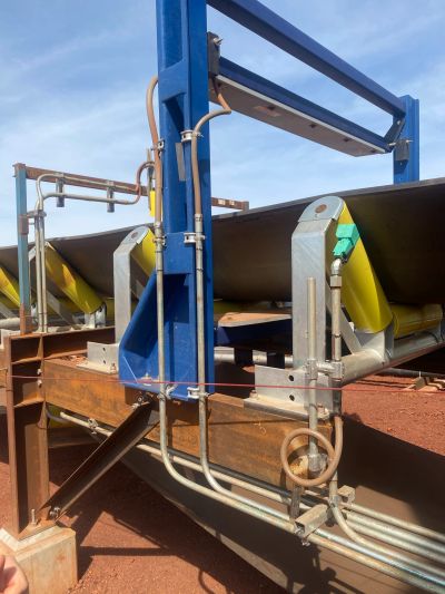 Tramp metal detector installed on an iron ore mining conveyor for metal detection and equipment protection.