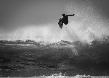 Dave Castro Photography surfer getting air black and white