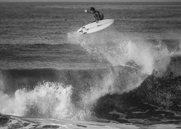 Dave Castro Photography surfer getting air black and white