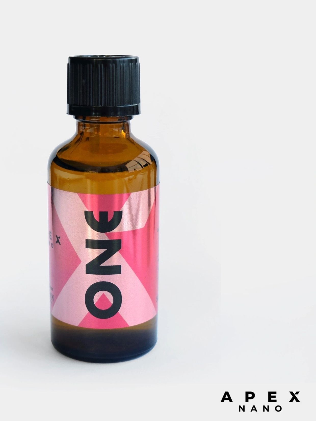 Amber bottle with a pink label reading 'ONE' and a black cap.