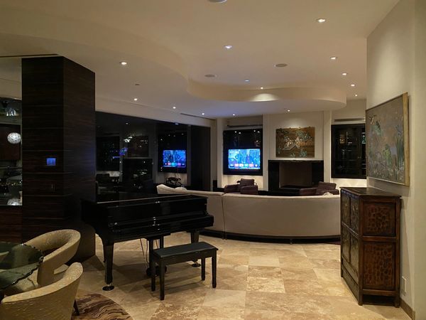 Elegant living room with grand piano and modern decor.