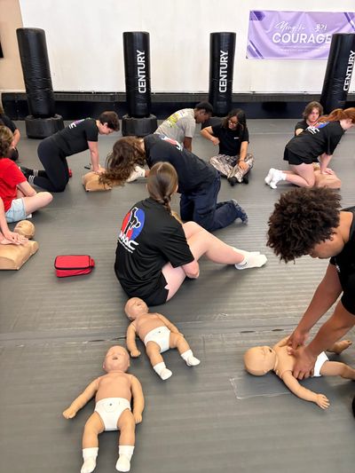 Group of Martial arts student counselors learning the importance and know how to save a life.