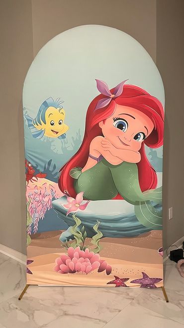 Cartoon of a mermaid and fish in underwater scene.
