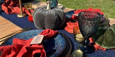 Elegant outdoor table setting with fall decor.