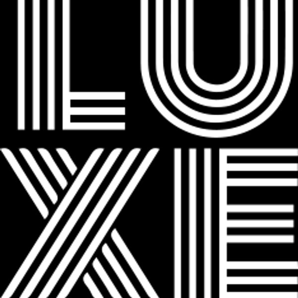 A black and white image of the word luxe. Luxe Fragrance Bar Logo