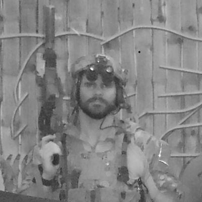 Black and white image of a soldier holding a rifle.